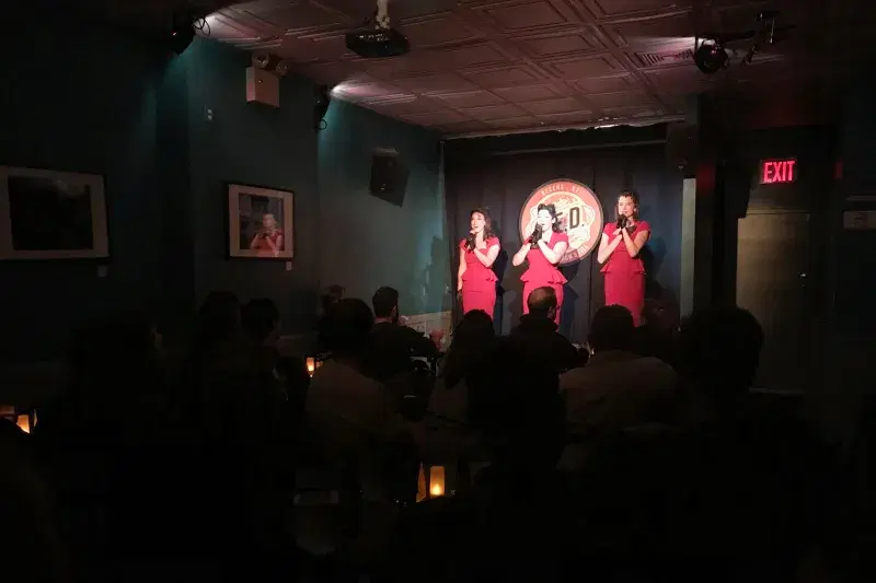 Three people in stage at  QED Astoria 