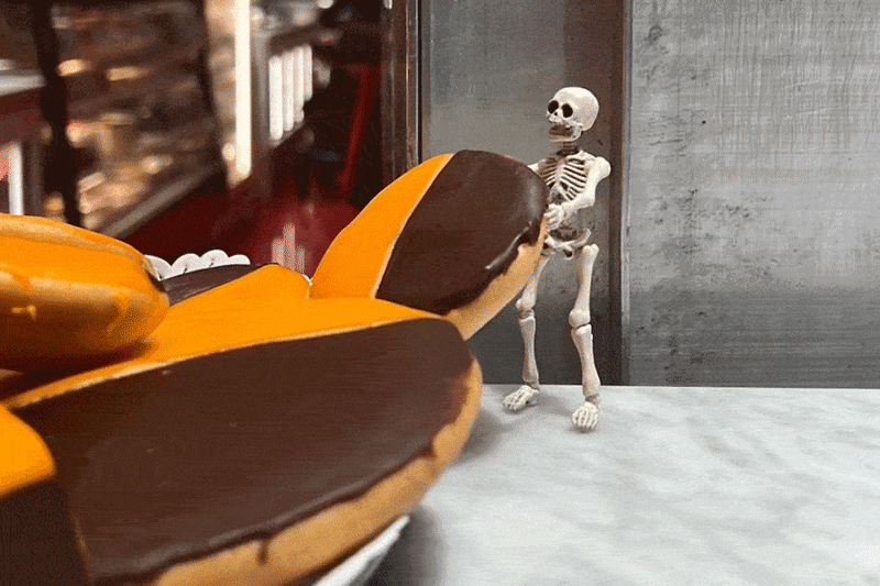 Skelly rolling a cookie along a table