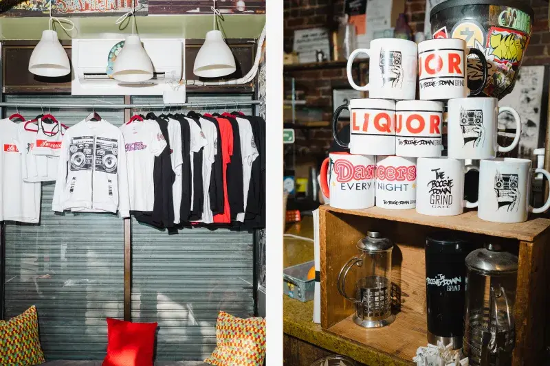 Shirts, coffee mugs, and a coffee maker at Boogie Down Grind
