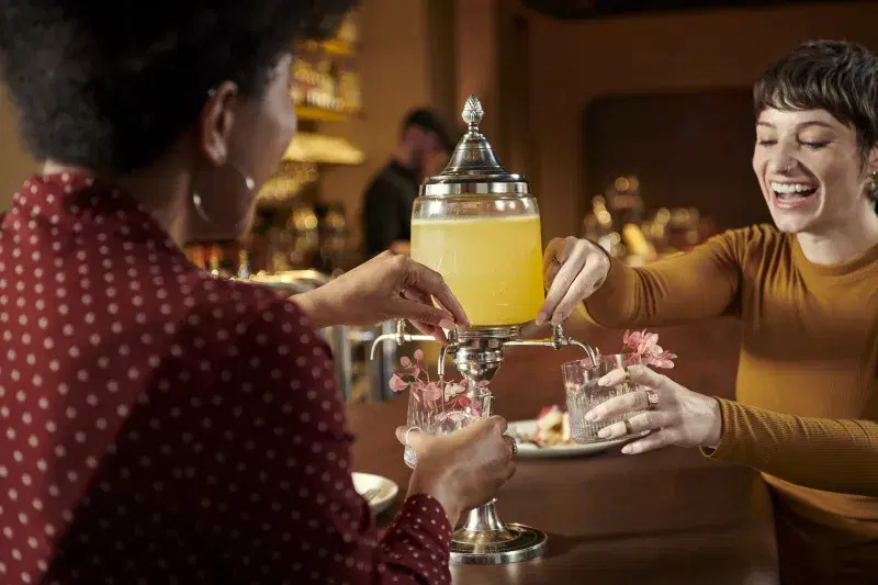 image of guests serving each other a cocktail